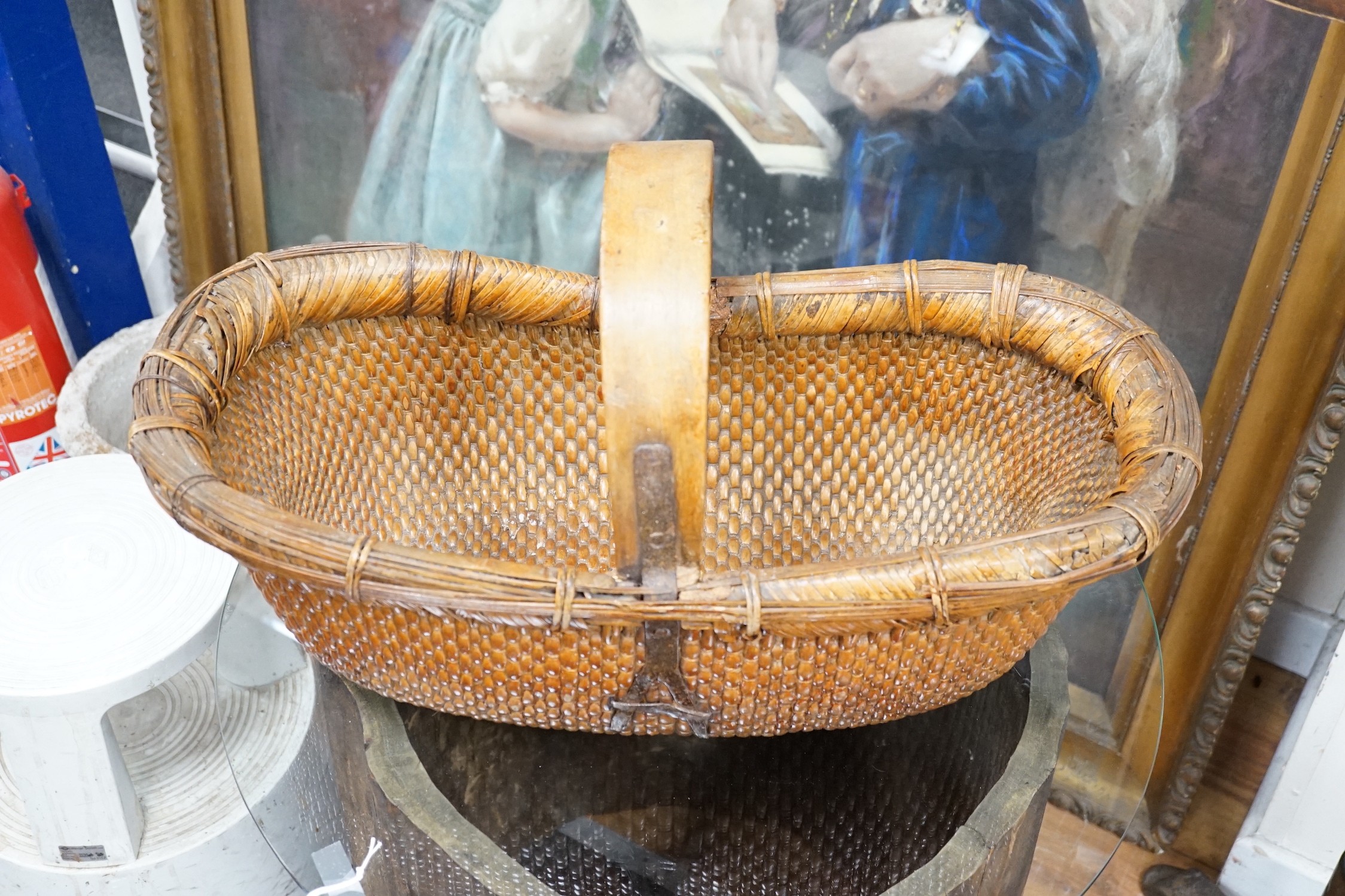 A brass mounted Chinese wicker trug basket. 67cm long